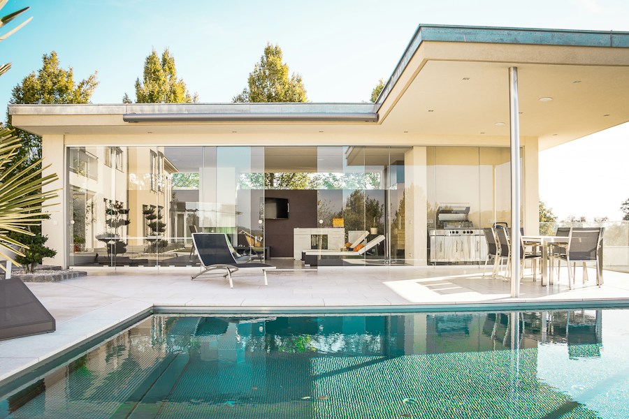 Modern house with glass doors and a landscaped patio